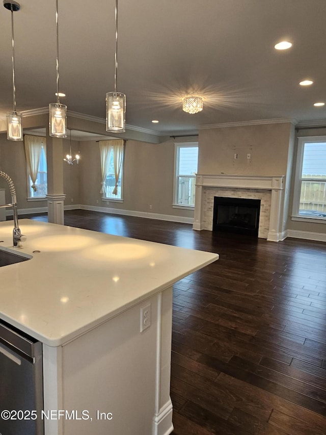 kitchen with ornamental molding, recessed lighting, a fireplace, dark wood-style flooring, and open floor plan