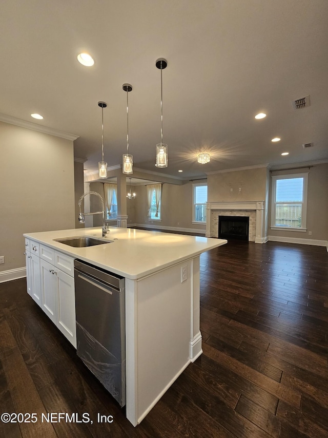 kitchen with recessed lighting, crown molding, a sink, and dishwasher