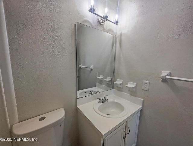 bathroom featuring toilet and vanity