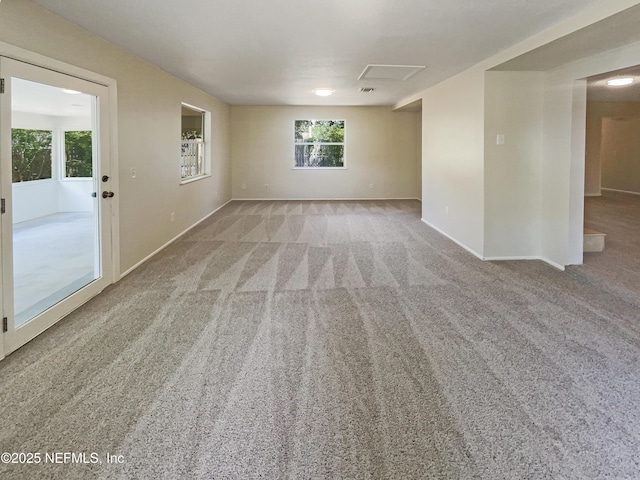spare room with baseboards and carpet