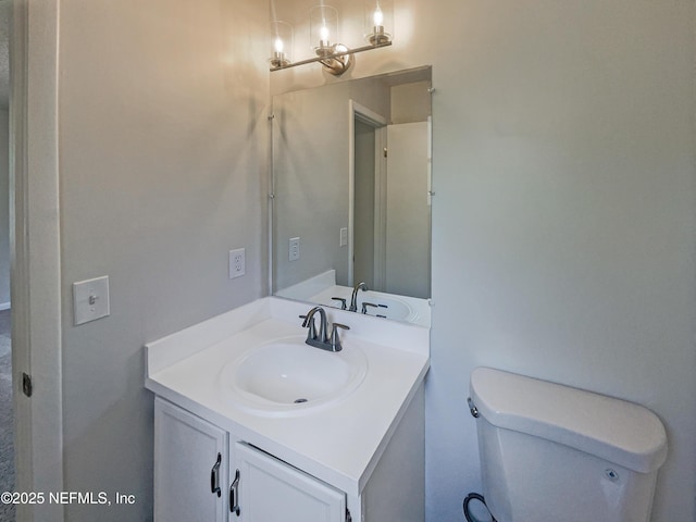 half bathroom featuring toilet and vanity