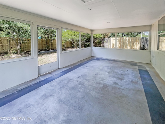 unfurnished sunroom featuring concrete floors