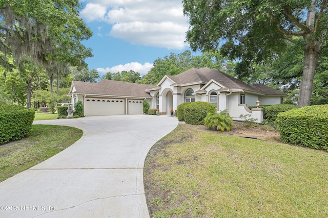 single story home with an attached garage, stucco siding, driveway, a front yard, and roof with shingles