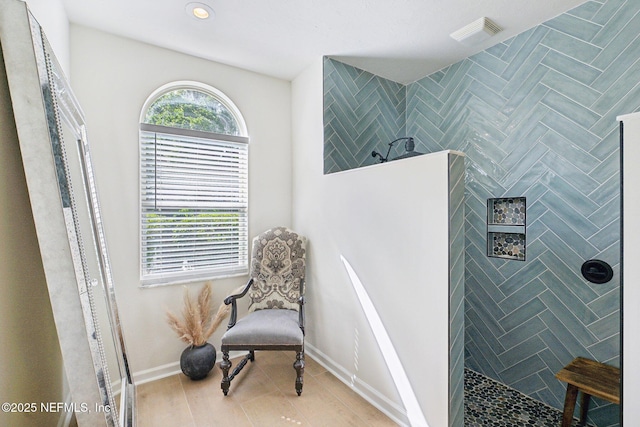 living area with wood finished floors, baseboards, and recessed lighting