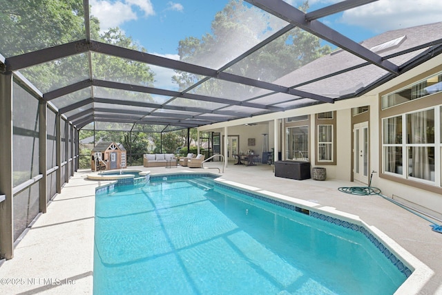 view of swimming pool with an outdoor hangout area, a shed, a patio area, and an outbuilding