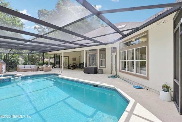 view of swimming pool with outdoor lounge area, a patio, a pool with connected hot tub, and glass enclosure
