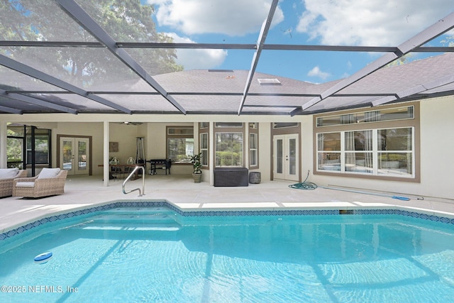 swimming pool with french doors, a patio, an outdoor living space, and a lanai