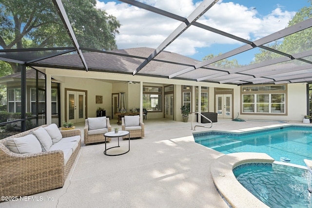 view of swimming pool with french doors, a patio area, a pool with connected hot tub, and glass enclosure
