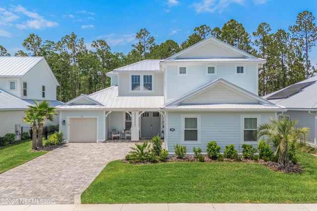 290 Marquesa Cir, Saint Johns, FL 32259 - traditional home with covered porch, metal roof, a garage, decorative driveway, and a front lawn