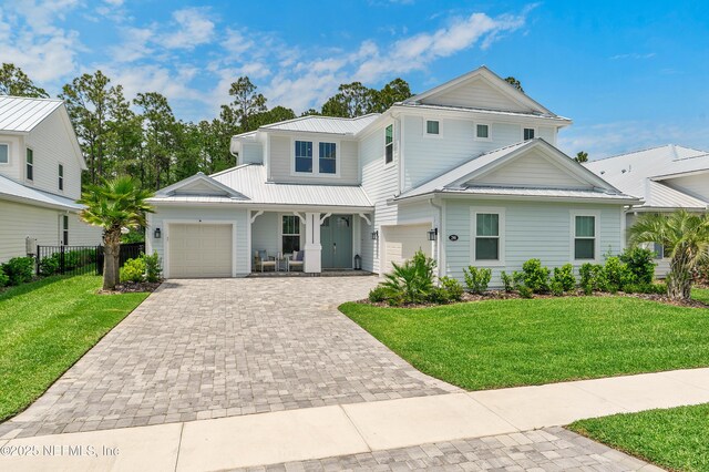 290 Marquesa Cir, Saint Johns, FL 32259 - traditional home featuring a porch, a garage, decorative driveway, fence, and a front lawn