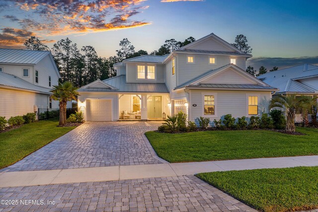 290 Marquesa Cir, Saint Johns, FL 32259 - traditional home featuring a porch, metal roof, a garage, decorative driveway, and a front lawn