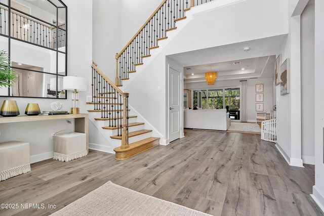 290 Marquesa Cir, Saint Johns, FL 32259 - stairs with wood finished floors, baseboards, a raised ceiling, a high ceiling, and recessed lighting