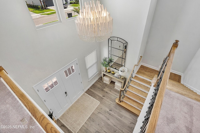 290 Marquesa Cir, Saint Johns, FL 32259 - entryway with baseboards, a chandelier, wood finished floors, and a towering ceiling