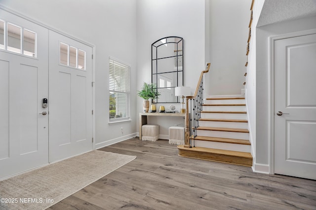 290 Marquesa Cir, Saint Johns, FL 32259 - foyer entrance featuring baseboards, stairs, a towering ceiling, and wood finished floors