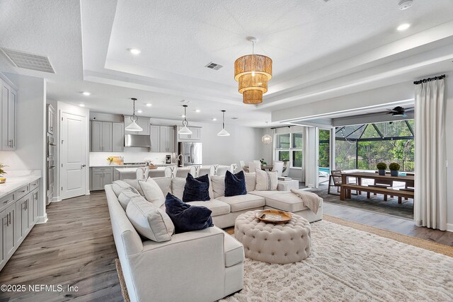 290 Marquesa Cir, Saint Johns, FL 32259 - living area with recessed lighting, a tray ceiling, visible vents, and wood finished floors