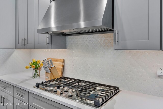 290 Marquesa Cir, Saint Johns, FL 32259 - kitchen featuring wall chimney range hood, stainless steel gas stovetop, gray cabinets, and light countertops
