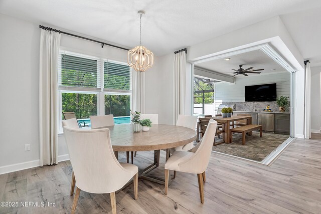 290 Marquesa Cir, Saint Johns, FL 32259 - dining area with baseboards, light wood-style flooring, and ceiling fan with notable chandelier