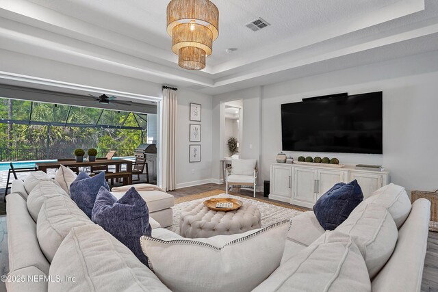 290 Marquesa Cir, Saint Johns, FL 32259 - living room with baseboards, a raised ceiling, wood finished floors, and visible vents