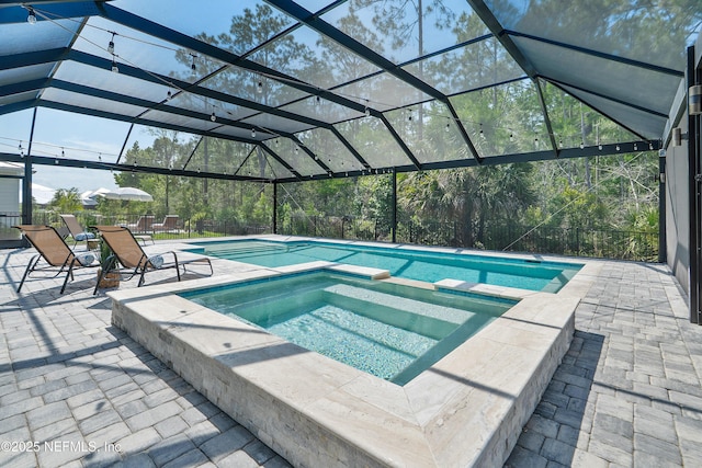290 Marquesa Cir, Saint Johns, FL 32259 - view of swimming pool featuring glass enclosure, a pool with connected hot tub, and a patio area