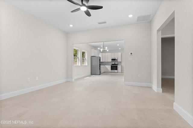 unfurnished living room with visible vents, ceiling fan with notable chandelier, and recessed lighting