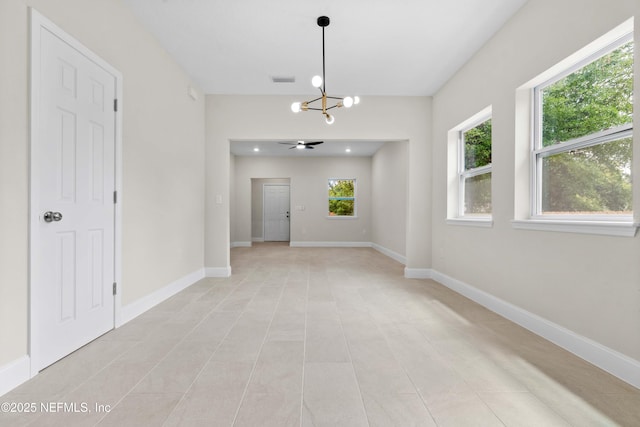 unfurnished dining area with a chandelier, baseboards, and light tile patterned floors