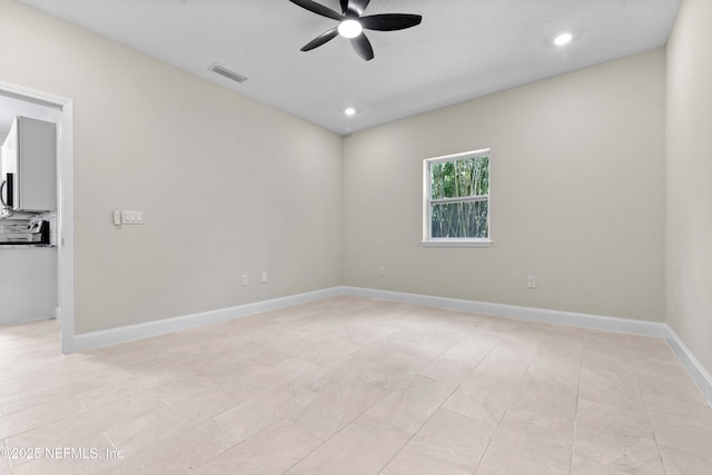 empty room featuring visible vents, light tile patterned floors, ceiling fan, and recessed lighting