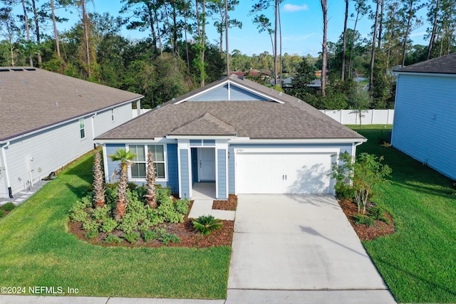 single story home with driveway, roof with shingles, a front yard, and a garage