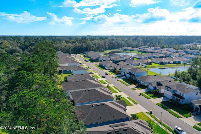 birds eye view of property with a residential view, a water view, and a forest view