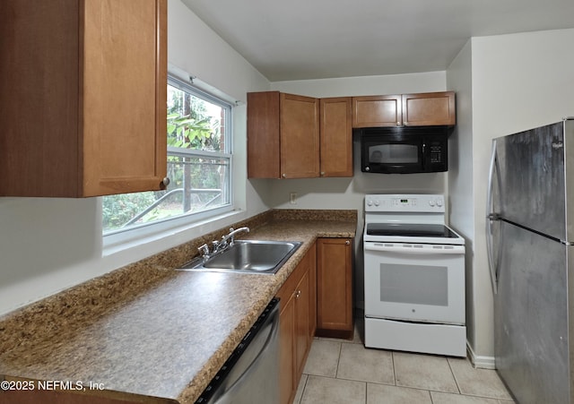 kitchen featuring a sink, stainless steel appliances, light tile patterned flooring, brown cabinetry, and dark countertops
