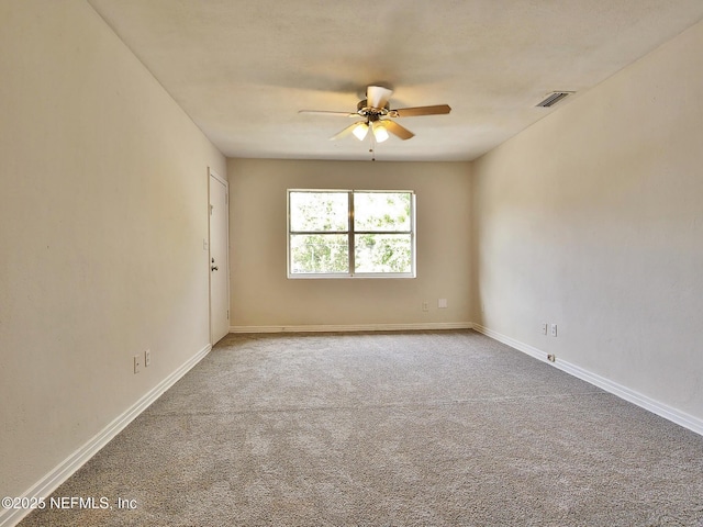 carpeted empty room with ceiling fan, baseboards, and visible vents