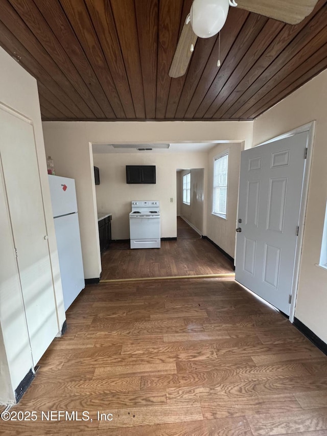 entryway with baseboards, wood finished floors, and wood ceiling