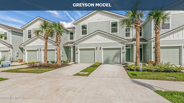 multi unit property with board and batten siding, driveway, and an attached garage