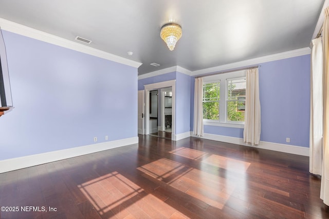 unfurnished room with baseboards, ornamental molding, wood finished floors, and visible vents