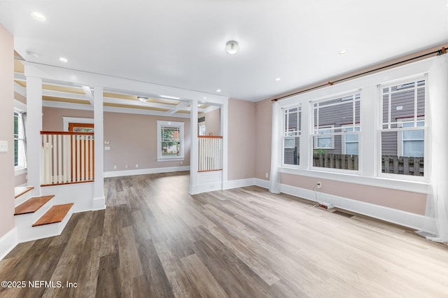 unfurnished living room featuring baseboards, recessed lighting, and wood finished floors