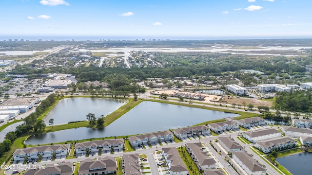 view of property location with a nearby body of water and nearby urban area