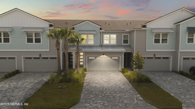 view of front of house featuring board and batten siding, an attached garage, and driveway