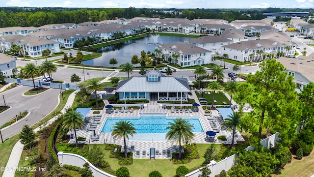 aerial view of a pool area and a large body of water