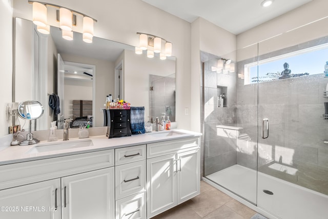 ensuite bathroom with a shower stall, double vanity, tile patterned flooring, and recessed lighting