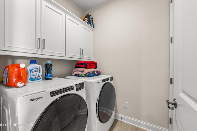 laundry room with cabinet space, washing machine and clothes dryer, and baseboards