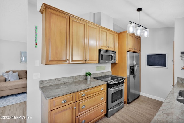 kitchen featuring light stone countertops, pendant lighting, baseboards, light wood finished floors, and appliances with stainless steel finishes
