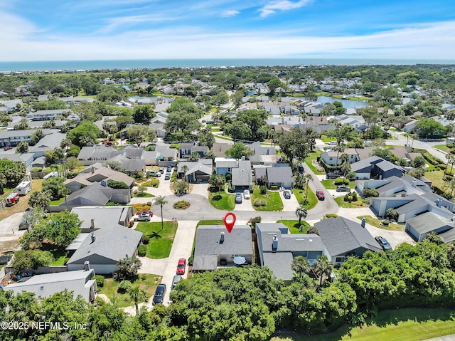 birds eye view of property with a water view and a residential view