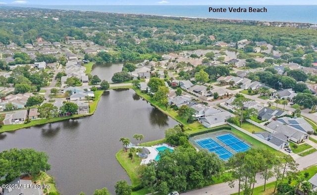 birds eye view of property with a water view and a residential view