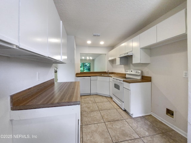 3801 Crown Point Rd Unit 1311, Jacksonville, FL 32257 - kitchen with white appliances, under cabinet range hood, a sink, white cabinetry, and visible vents