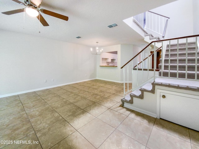 3801 Crown Point Rd Unit 1311, Jacksonville, FL 32257 - unfurnished living room featuring visible vents, ceiling fan with notable chandelier, tile patterned flooring, and stairway