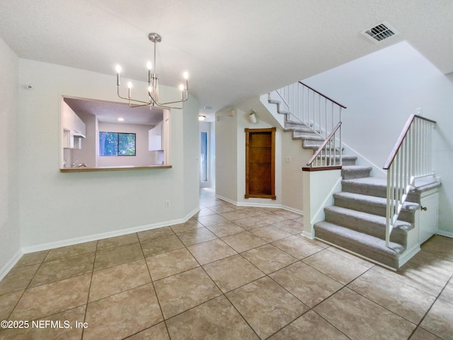 3801 Crown Point Rd Unit 1311, Jacksonville, FL 32257 - interior space featuring an inviting chandelier, stairway, tile patterned floors, visible vents, and baseboards