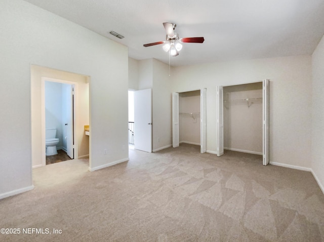 3801 Crown Point Rd Unit 1311, Jacksonville, FL 32257 - unfurnished bedroom featuring connected bathroom, carpet flooring, visible vents, baseboards, and two closets