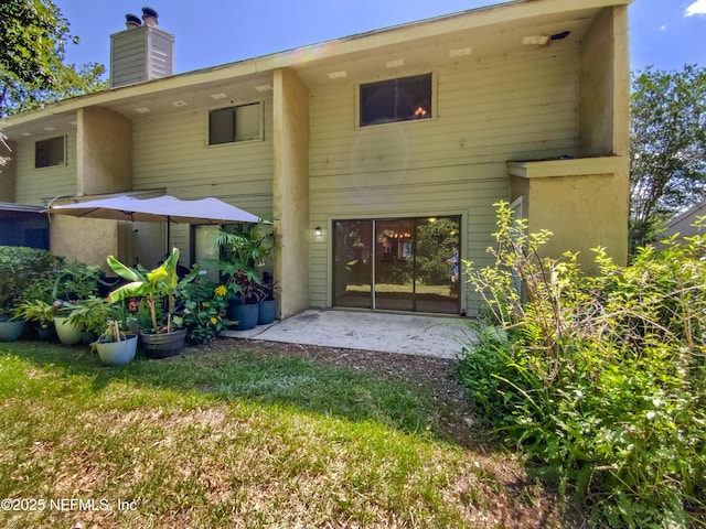 3801 Crown Point Rd Unit 1311, Jacksonville, FL 32257 - rear view of property with a chimney and a patio