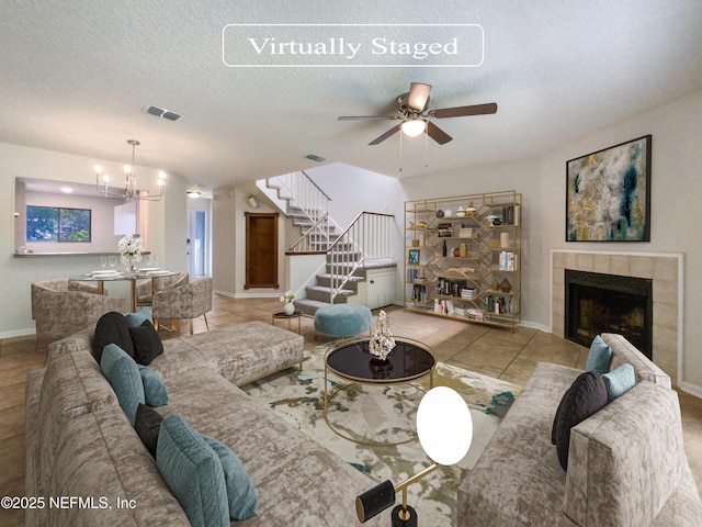 3801 Crown Point Rd Unit 1311, Jacksonville, FL 32257 - living area featuring stairway, ceiling fan with notable chandelier, a fireplace, baseboards, and visible vents