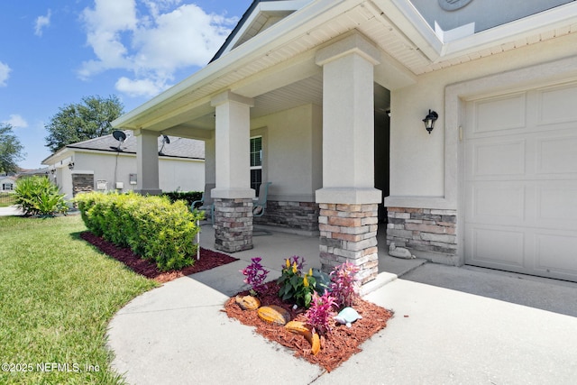417 Palazzo Cir, Saint Augustine, FL 32092 - entrance to property with a garage, stone siding, a porch, stucco siding, and a yard