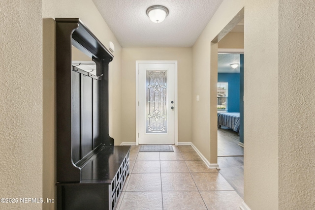 417 Palazzo Cir, Saint Augustine, FL 32092 - mudroom with a textured wall, a textured ceiling, and light tile patterned floors